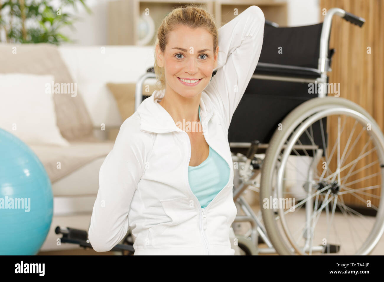 young woman doing exercise with a fitball in a gym Stock Photo