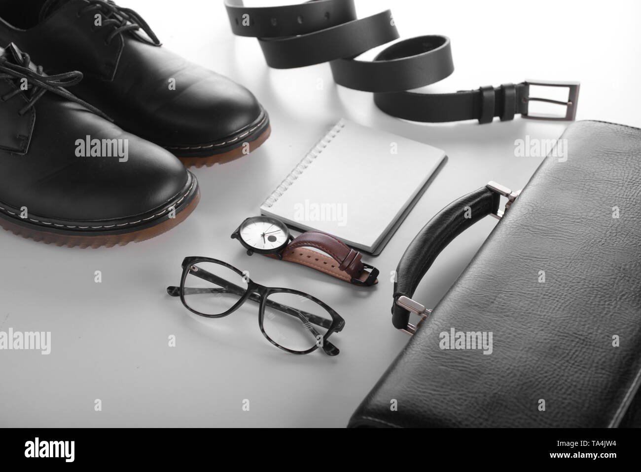 Stylish men's accessories with notebook on white background Stock Photo