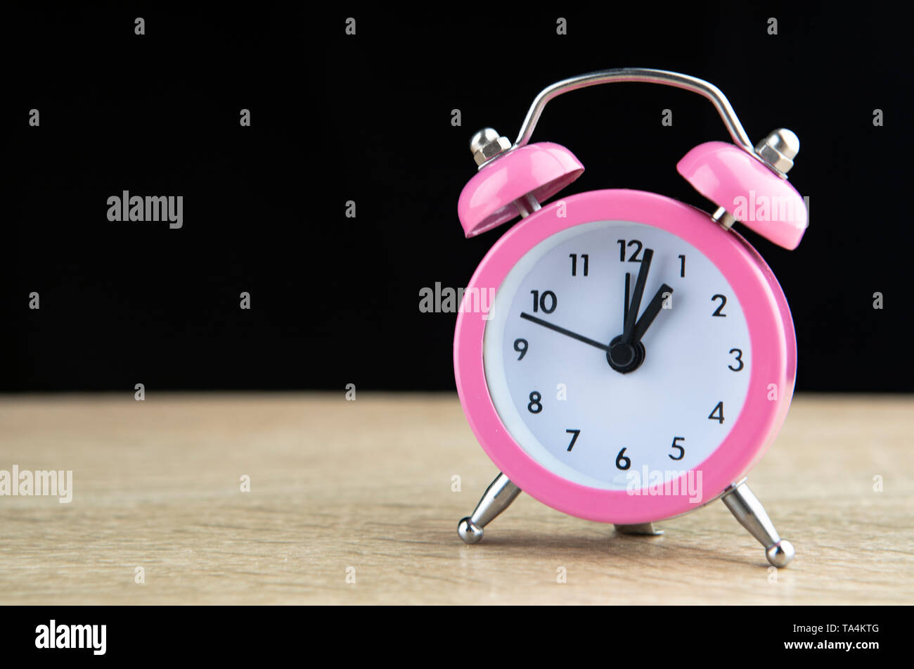 Retro alarm clock on a black background Stock Photo