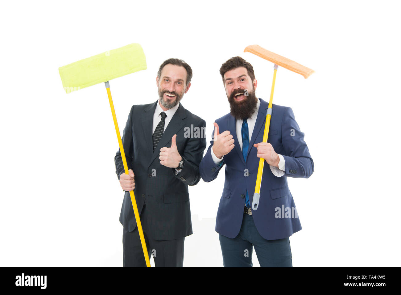 businessmen clear wall to white. clean slate. cleaning company. clean business. mature bearded men in formal suit hold householding mop. Partnership and teamwork. Feel the fragrance. we did it. Stock Photo