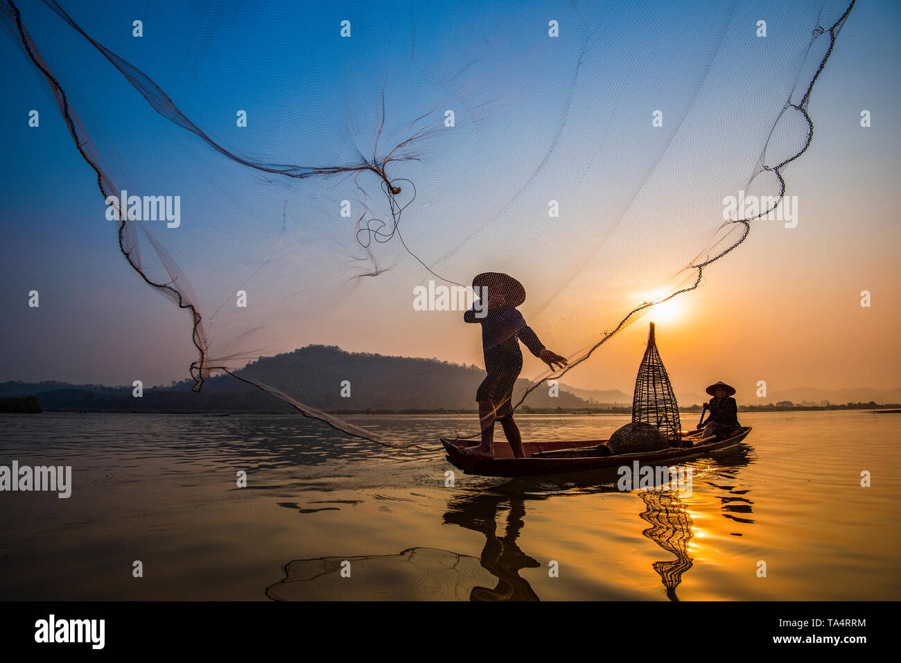 Fisherman on boat river sunset / Asia fisherman net using on wooden boat  casting net sunset or sunrise in the Mekong river - Silhouette fisherman  boat Stock Photo - Alamy