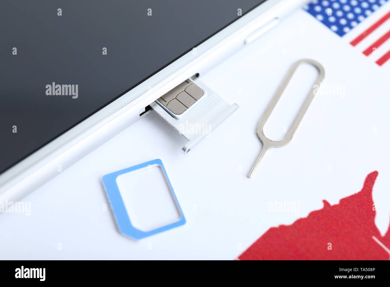 Mobile phone with sim card and key Stock Photo - Alamy