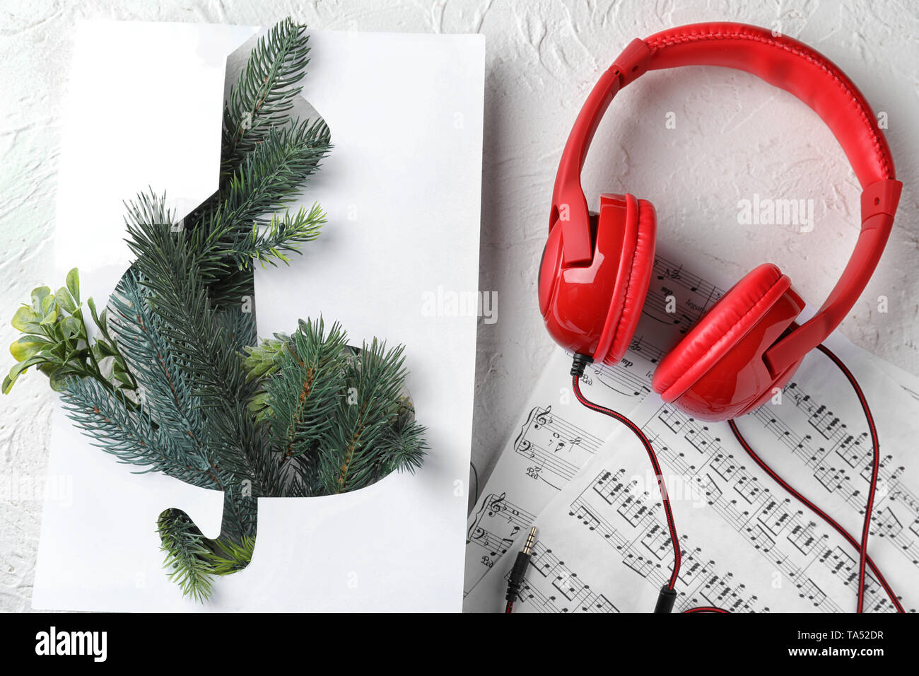 Composition with violin clef, note sheets and headphones on table Stock Photo