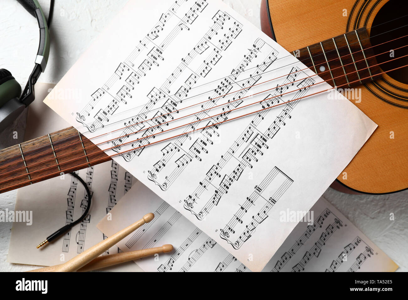 Composition with guitar and music sheets on white background Stock Photo