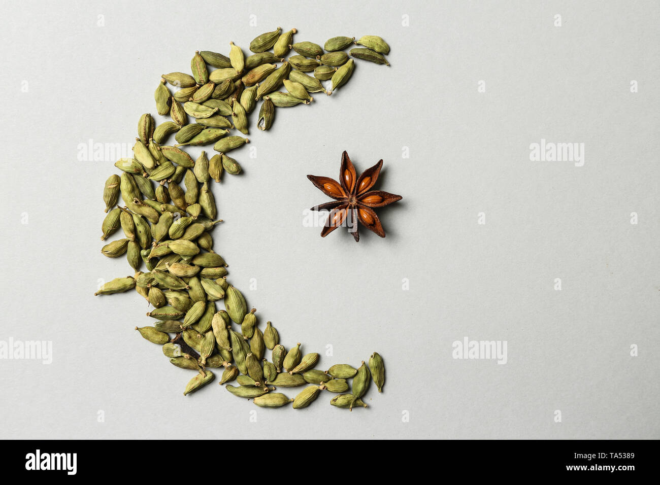 Halfmoon and star made of spices as symbol of Islam on light