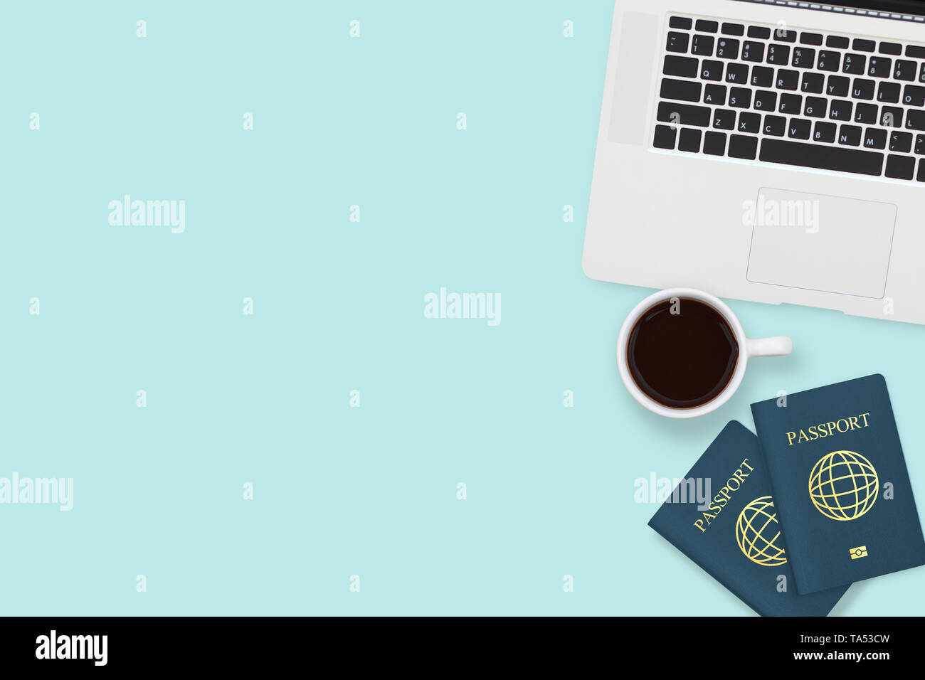 flat lay of two passport , coffee cup and computer laptop on pastel blue color background with copy space. travel , visa and vacation concept Stock Photo