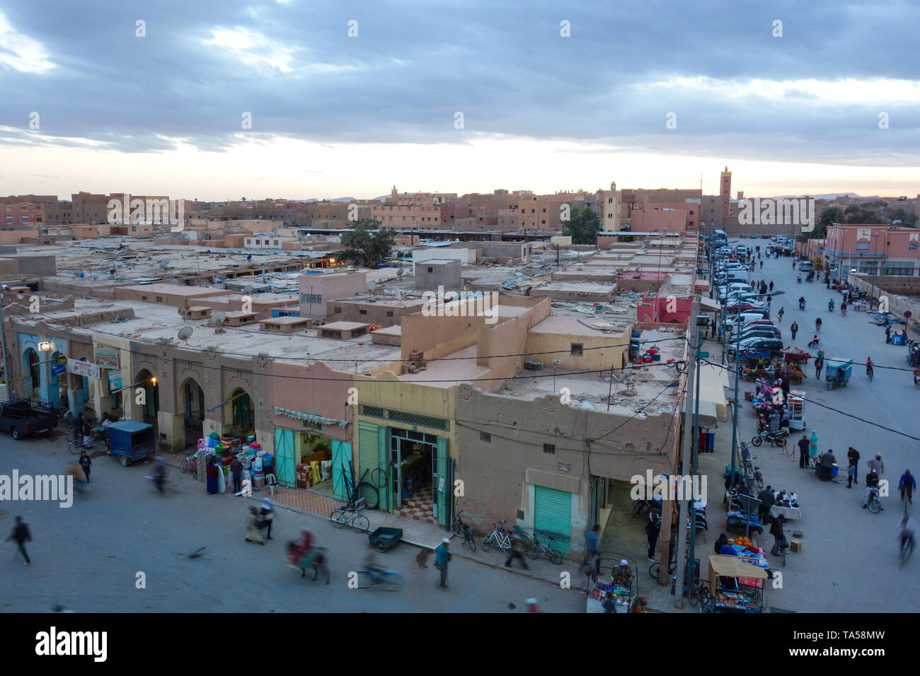 Rissani, Morocco - March 21st, 2019: A view down onto the main street with busy locals during sunset. Stock Photo