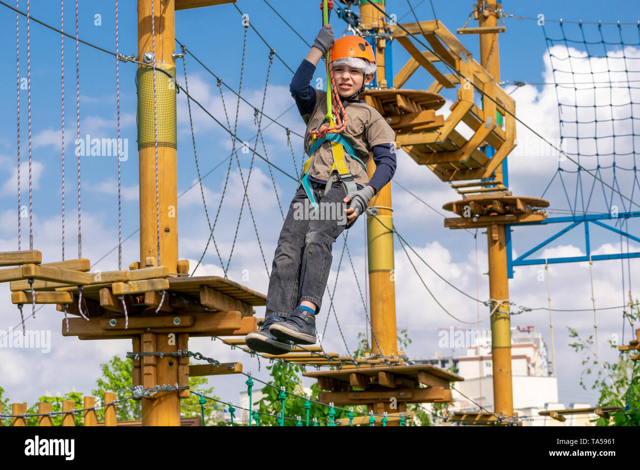 Boy practicing his climbing skills in a rope park Stock Photo Alamy