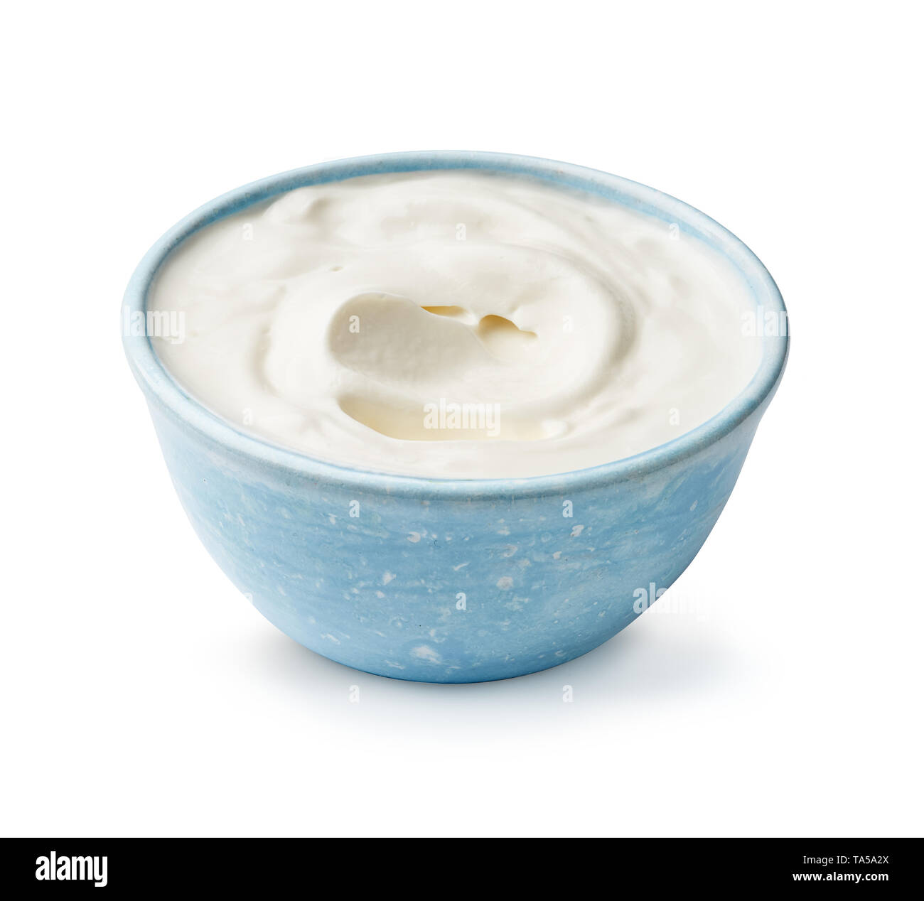 Sour cream or yogurt isolated on white background. Blue bowl of yoghurt. Stock Photo
