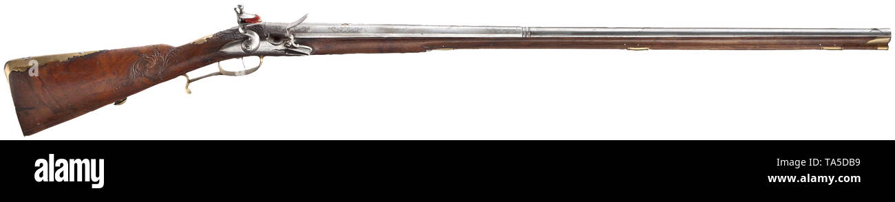 A flintlock rifle by Johann Andreas Kuchenreuter near Regensburg, circa 1780 Octagonal to round barrel with smooth bore in 15 mm calibre. Silver spider front sight, the top of the barrel with silver inlaid bands. Over the chamber gold-lined horseman mark 'ICK' and silver inlaid signature 'Ioh. Andre Kuchenreuter An Regensburg'. The tang inscribed '1'. Flintlock with domed plate and repeated signature 'I. A. Kuchenreuter'. Full walnut stock with finely carved scrolling leaves and rocailles. On the cheek cartouche with depiction of a fox, carrying , Additional-Rights-Clearance-Info-Not-Available Stock Photo