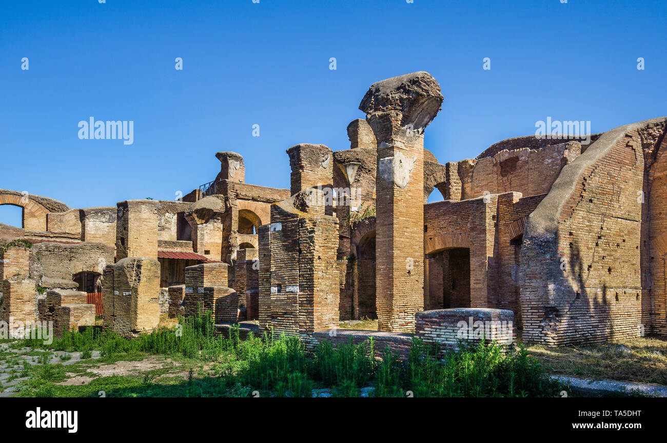 Cardo degli Aurighi (Street of the Charioteers) at the archeological site of the Roman settlement of Ostia Antica, the ancient harbour of the city of  Stock Photo