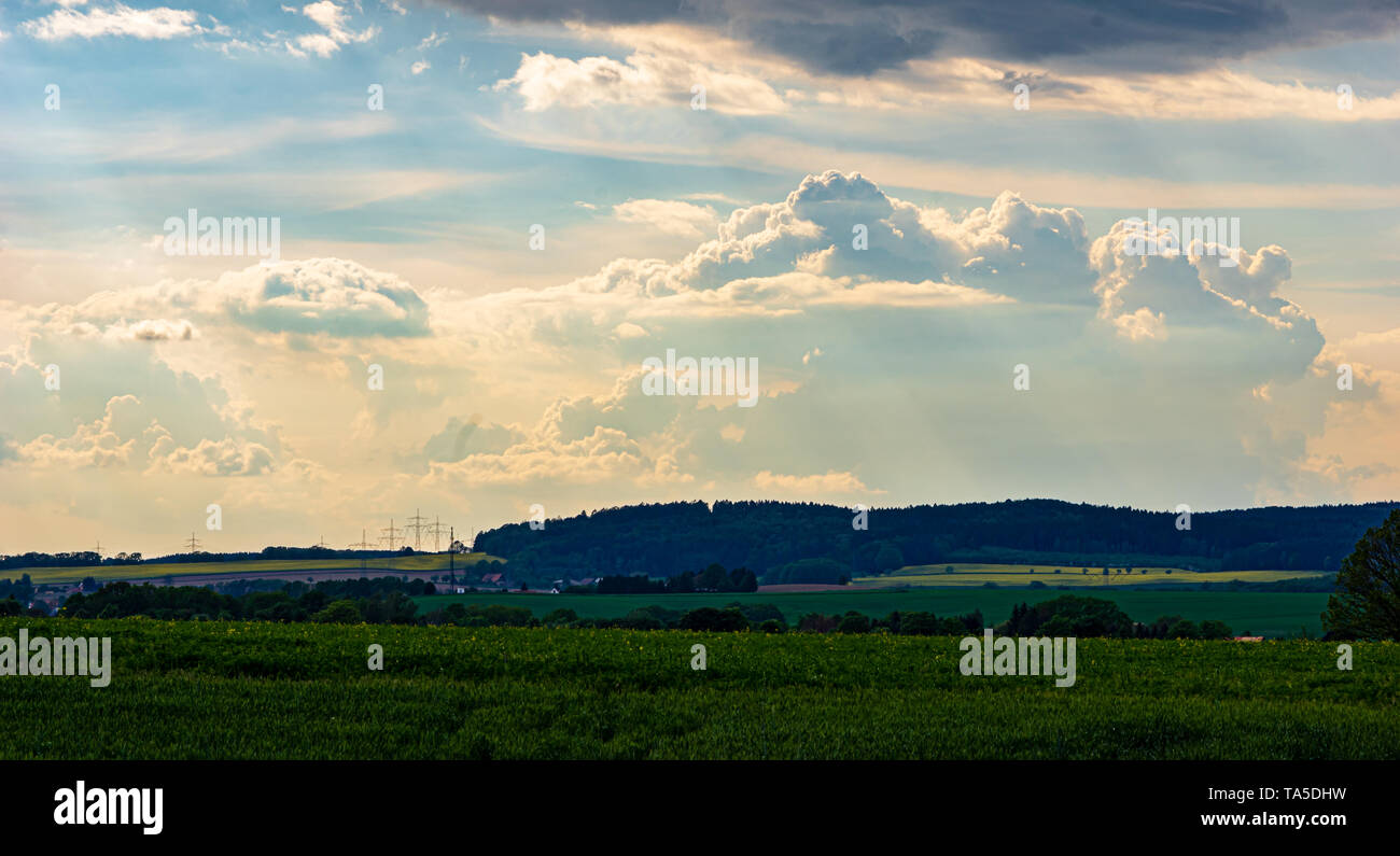 dramatic sky with sunrays breaking through storm clouds Stock Photo