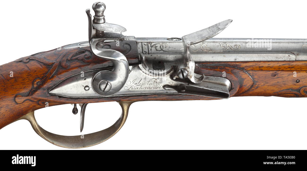A pair of flintlock pistols, Johann Andreas Kuchenreuter, Steinweg near Regensburg, circa 1780 Octagonal barrels transforming into round, finely rifled bores in 12 mm calibre with silver spider front sights. On barrel tops tendril-shaped silver inlays and signatures 'I. CHRISTOPH KUCHENREUTER' and silver-lined rider's marks. Lightly cut flintlocks with set triggers and engraved signatures 'Joh. Andre Kuchenreiter'. Carved walnut stocks with horn nosepieces and smooth brass furnitures. Original wooden ramrods with horn tips. Length 42 cm each. Pis, Additional-Rights-Clearance-Info-Not-Available Stock Photo