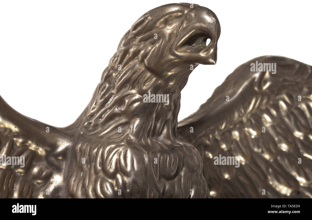 An eagle-shaped finial for a Jingling Johnny 1st model after Prussian pattern Nickel-plated eagle assembled from hollow stamped sheet metal parts after Prussian pattern but without the crown, in its beak a hole for the cord of the Jingling Johnny flag. Screw affixed onto a wooden socket. Total height ca. 230 mm. historic, historical, 20th century, Editorial-Use-Only Stock Photo