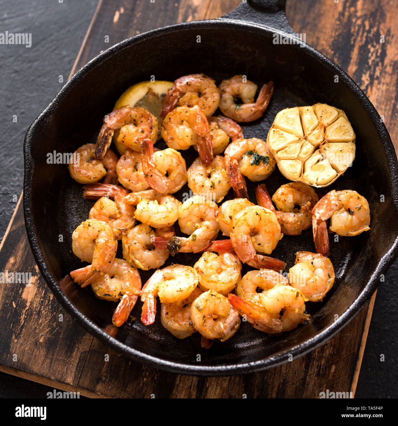 Roasted Shrimps With Lemon Garlic And Herbs Seafood Shelfish Shrimps Prawns Grilled With Spices Garlic And Lemon On Black Stone Background Copy Stock Photo Alamy