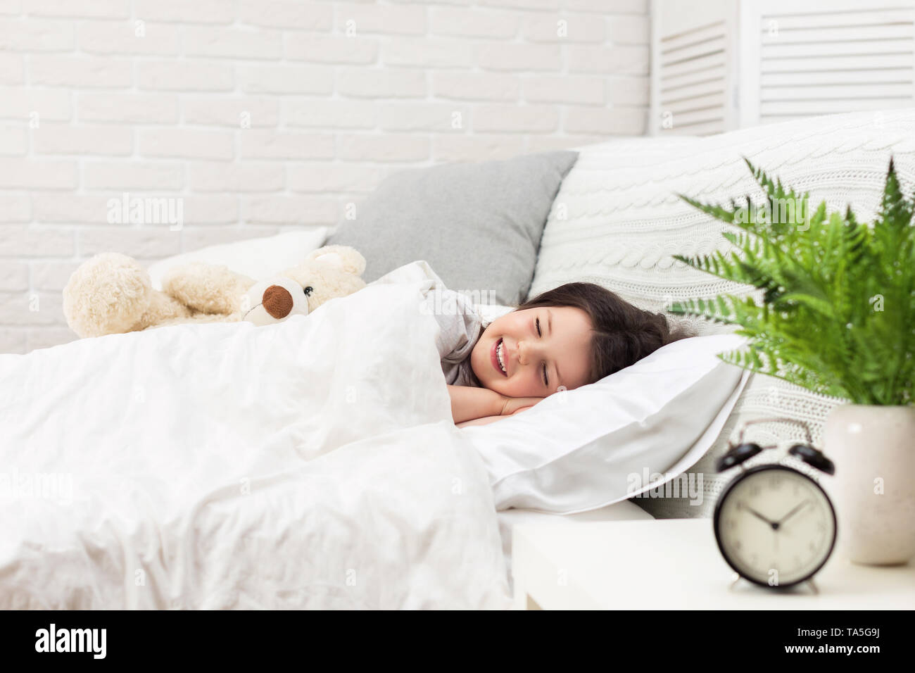 Cute little child girl sleeping with teddy bear in her bed Stock Photo ...