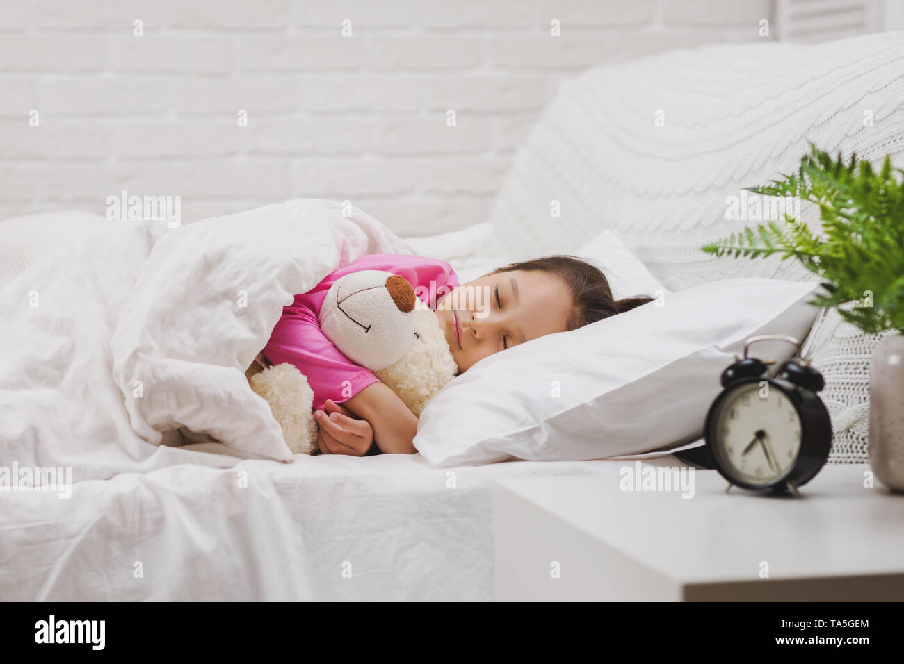 Cute little child girl sleeping with teddy bear in her bed Stock Photo ...