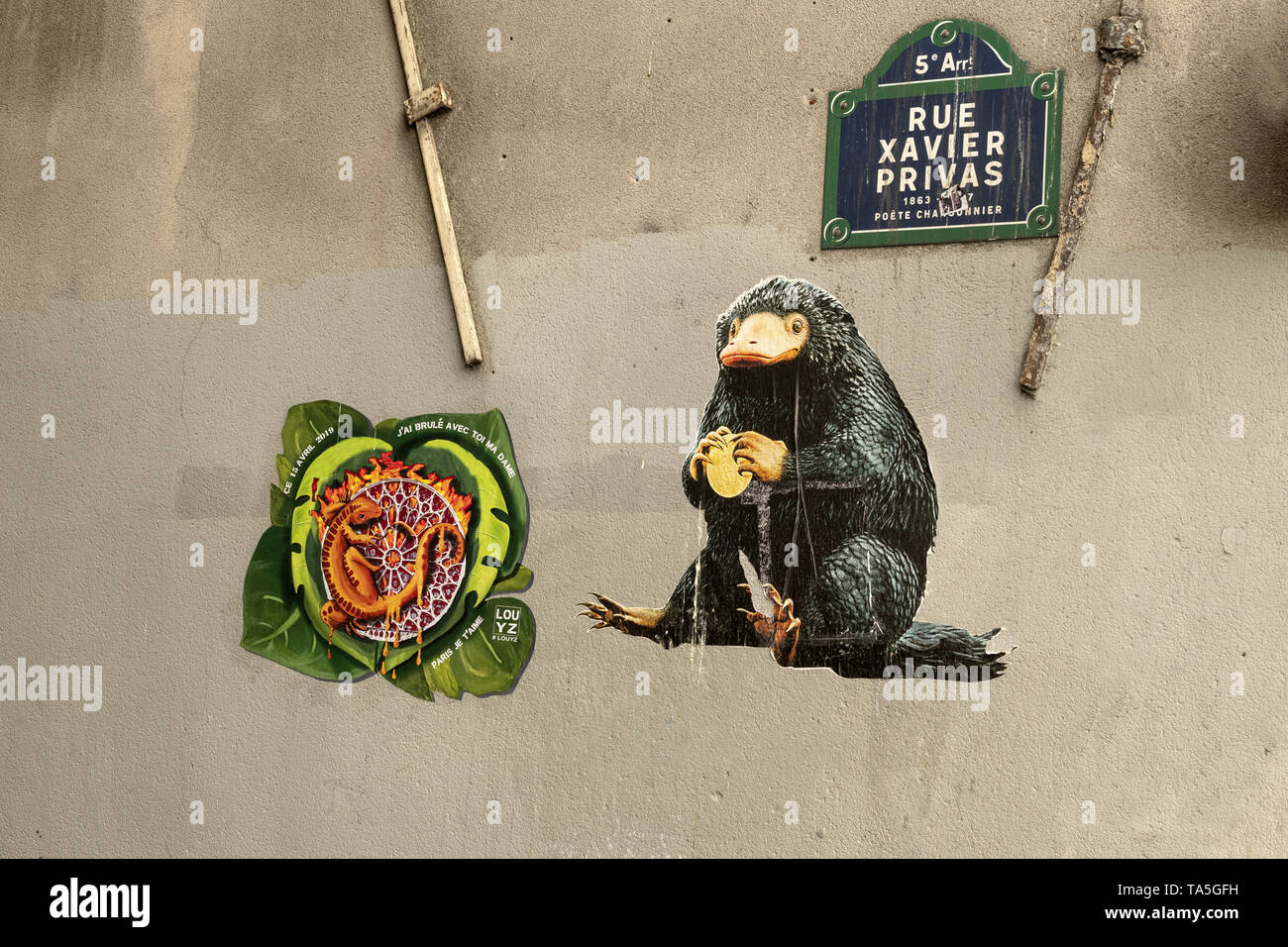 PARIS, FRANCE - APRIL 24: Street art graffiti pieces depicting (Left) a  Notre Dame cathedral burning with a lizard attached to the famous stained  gla Stock Photo - Alamy