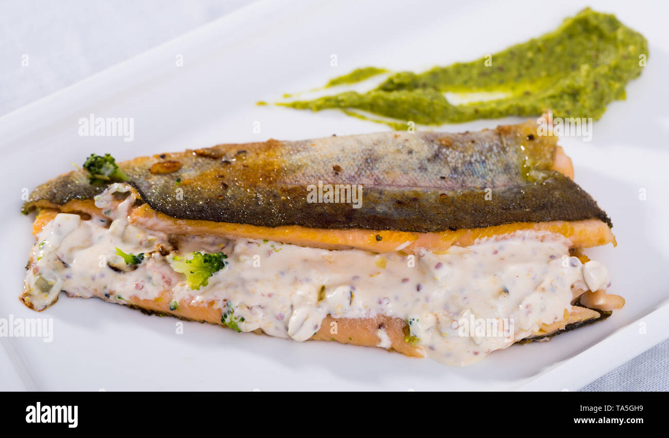 Delicious fried trout fillet with steamed broccoli and tartare sauce