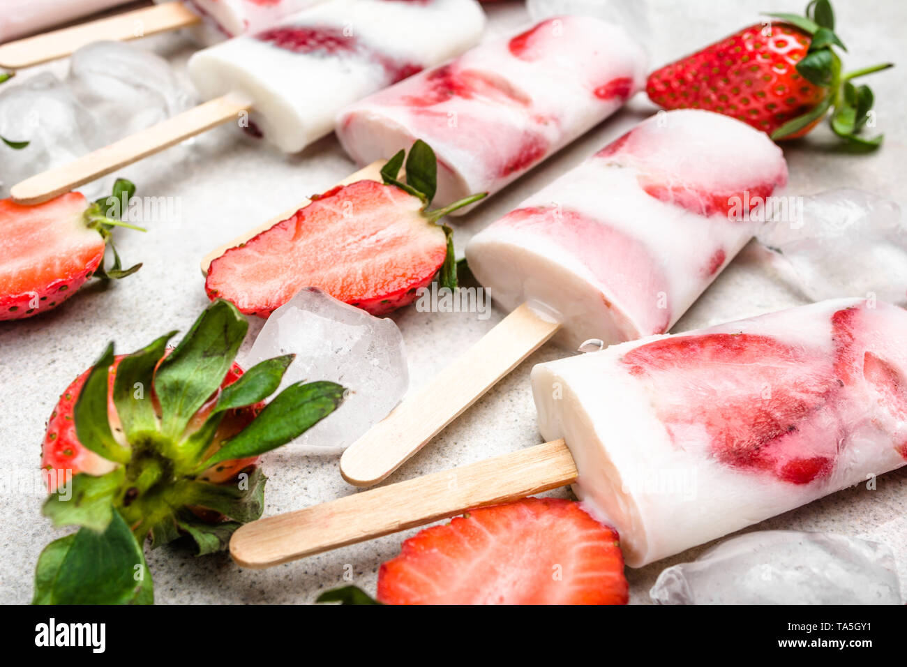 Strawberry ice cream on sticks popsicles. Fruit lollipops Stock Photo