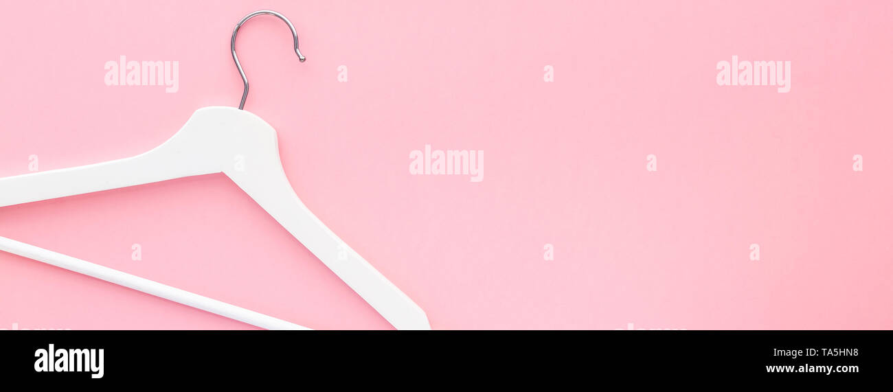 Creative top view flat lay white wooden hangers pastel millennial pink ...