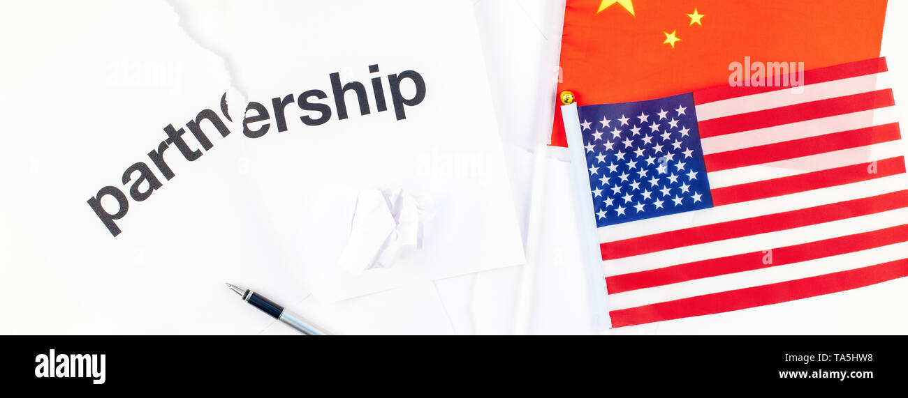 Creative top view flat lay of China and USA flag and broken partnership contract with pen and copy space on white background in minimal style. Concept Stock Photo