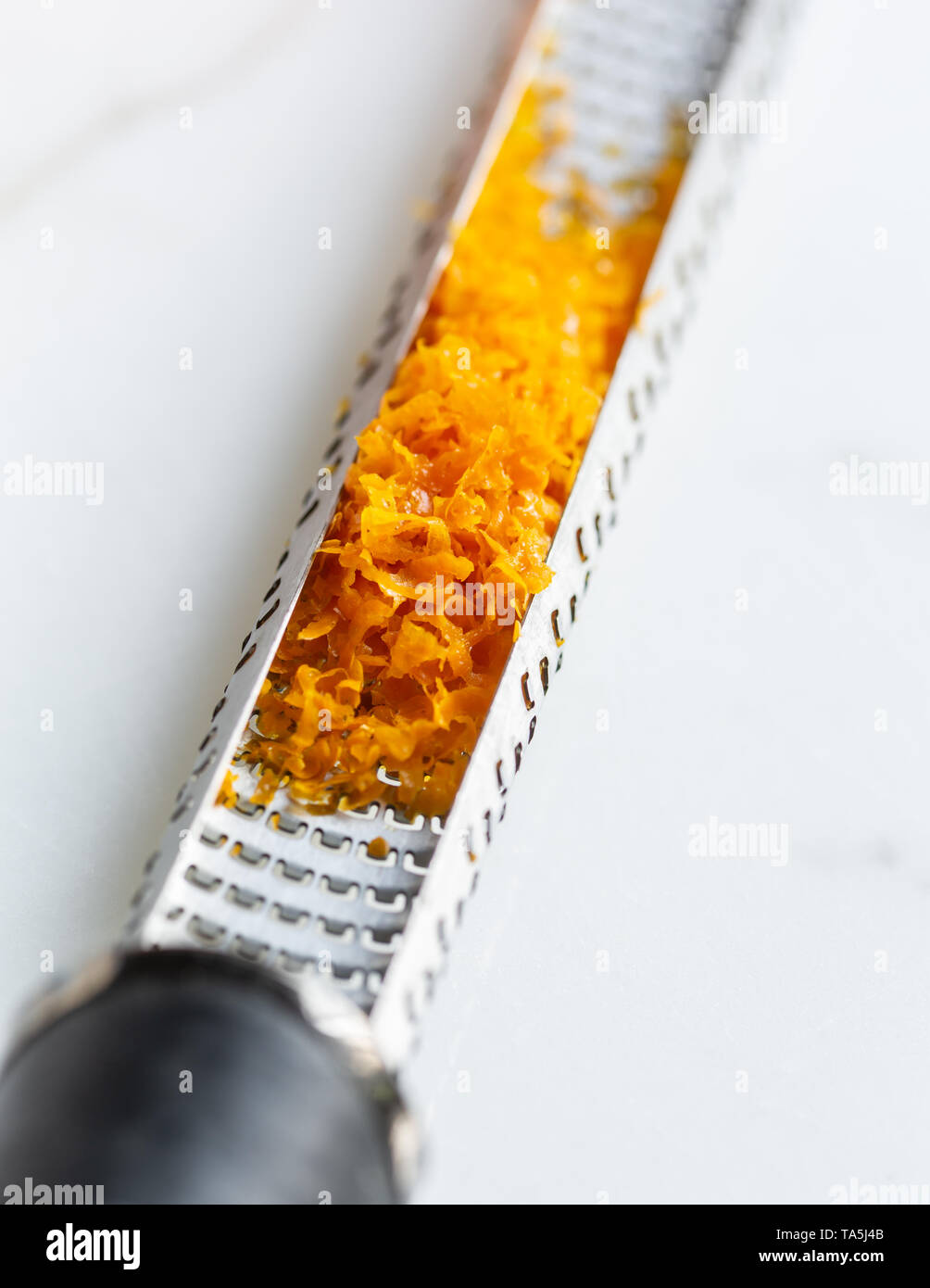 orange zest on grater Stock Photo