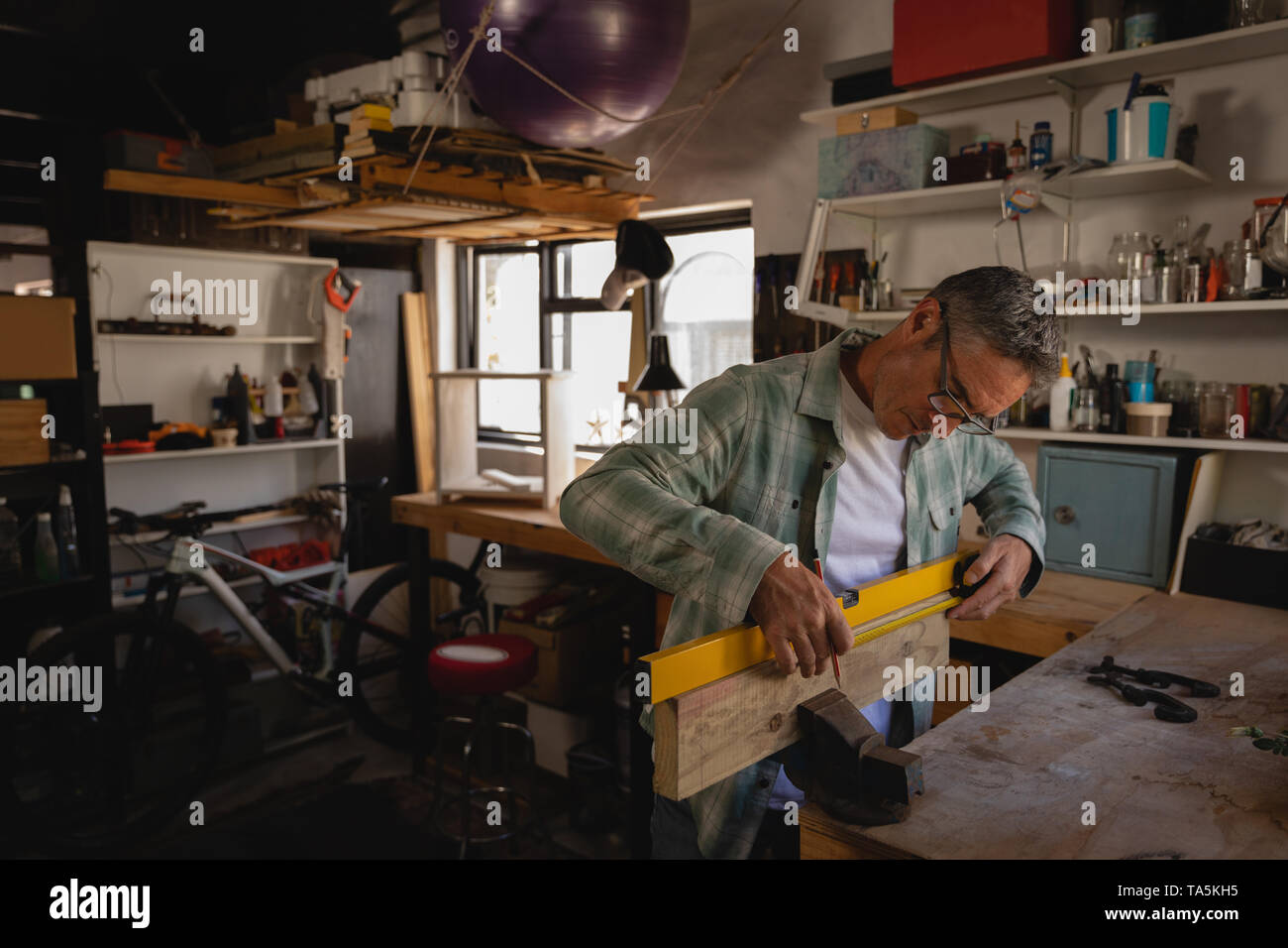 Mature carpenter working in workshop Stock Photo