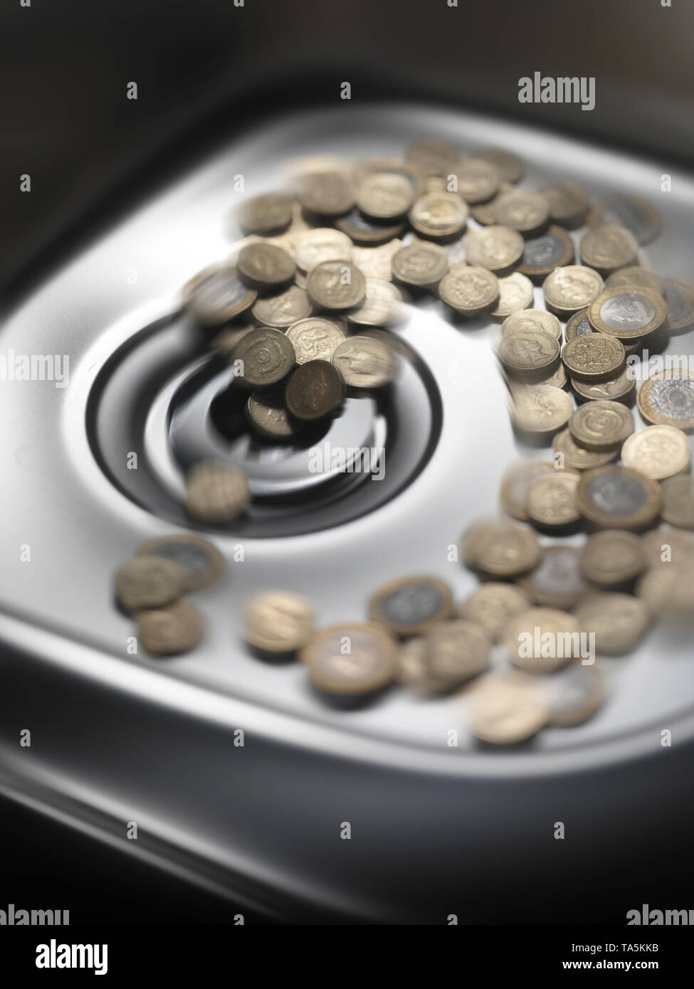 Throwing money down the drain hires stock photography and images Alamy