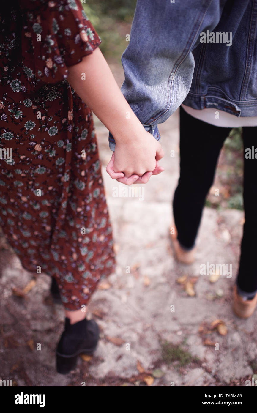 Teenage Boy And Girl With Holding Hands Walking Outdoors Relationship Love Concept Stock Photo Alamy