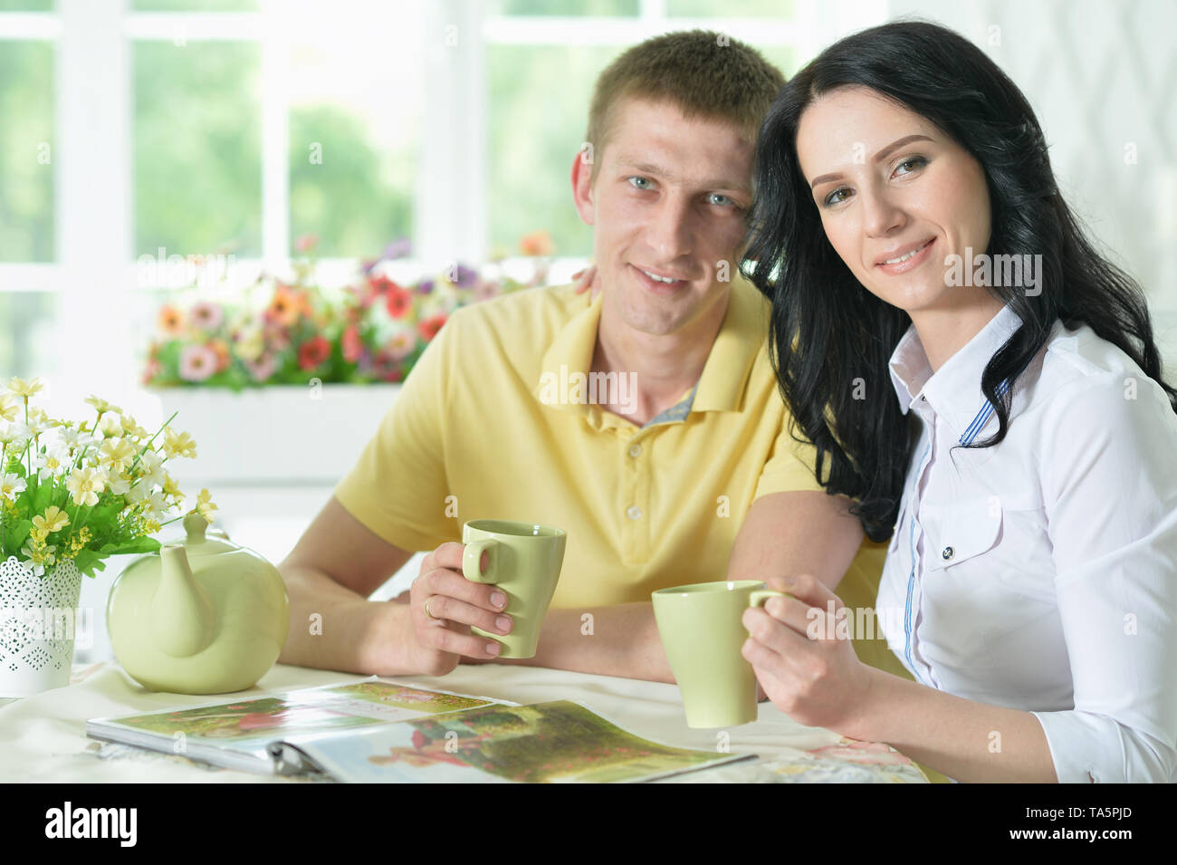 Portrait of young couple reading interesting book Stock Photo