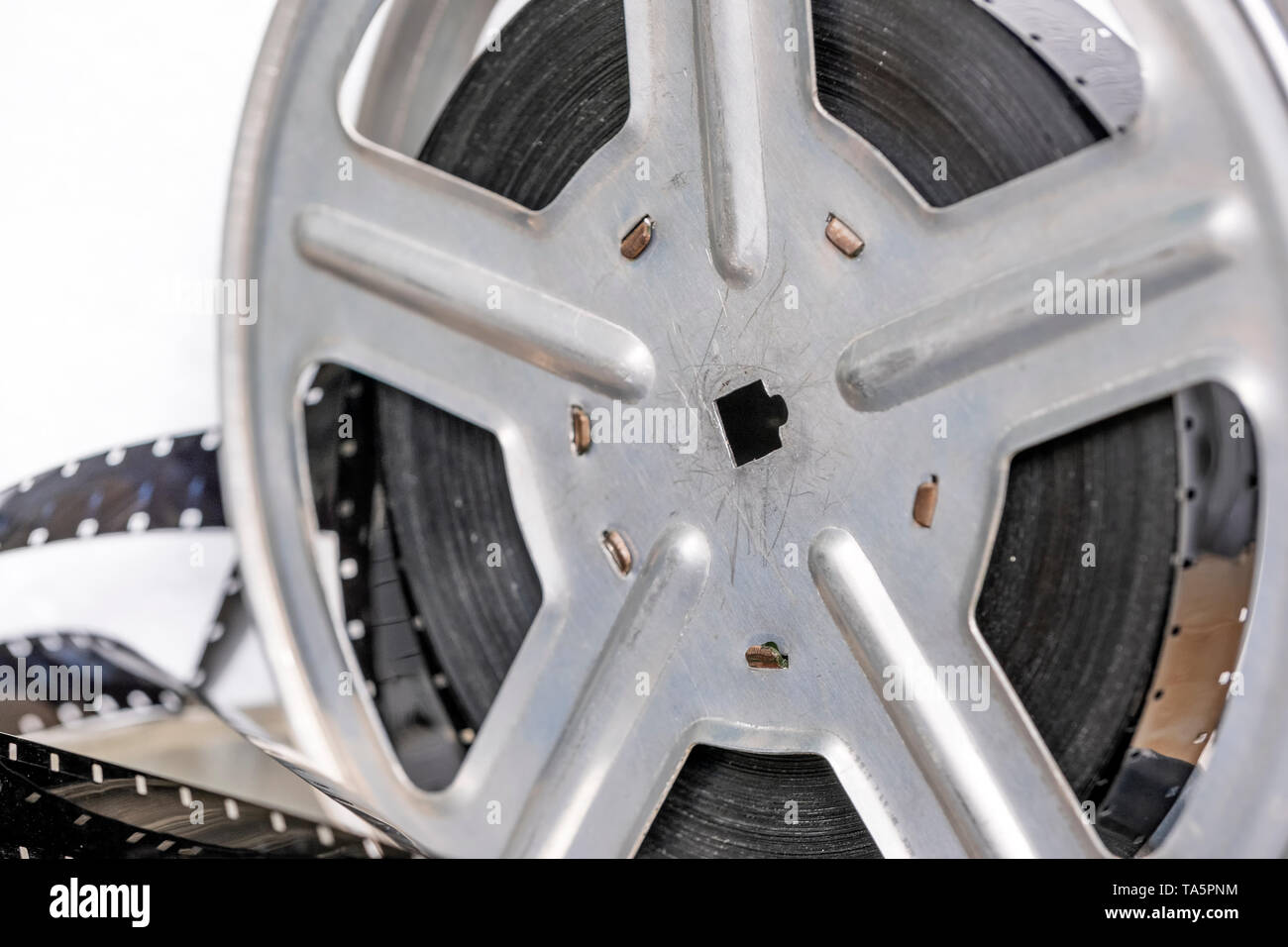 Metal reel with retro film strip sixteen millimeters close-up Stock Photo