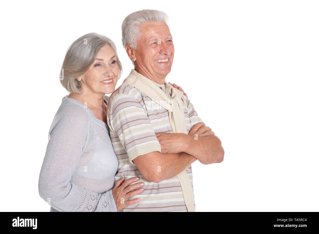 Portrait of happy senior couple hugging on white background Stock Photo