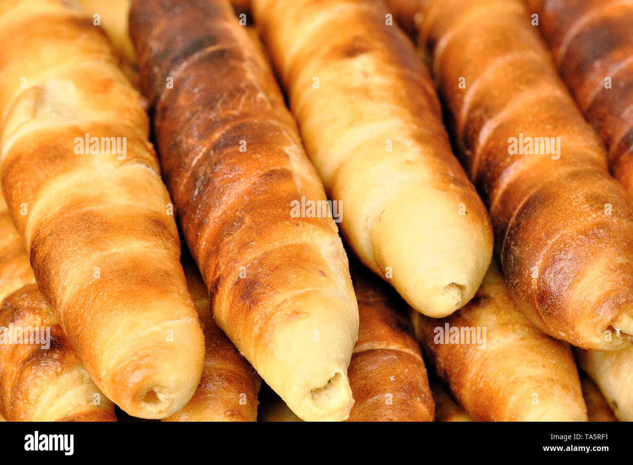 Grilled sausages in the dough outdoors on a bright sunny spring day Stock Photo
