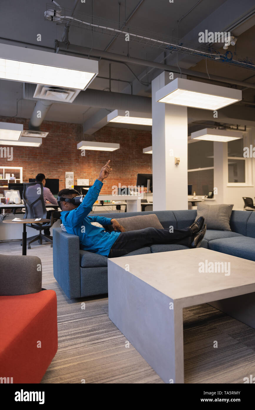 Businessman using virtual reality headset Stock Photo