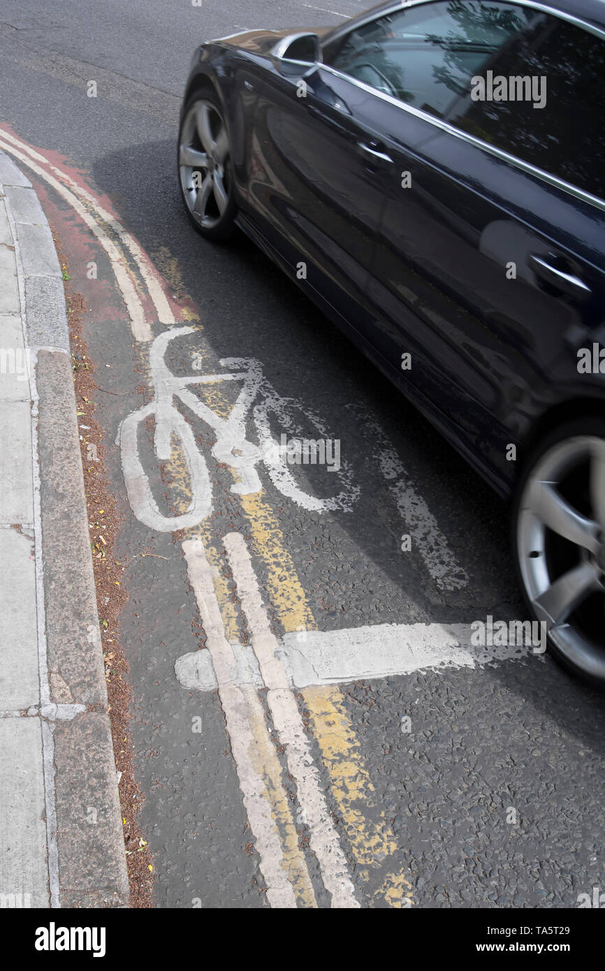 a car passes an extremely narrow cycle lane in richmond upon thames
