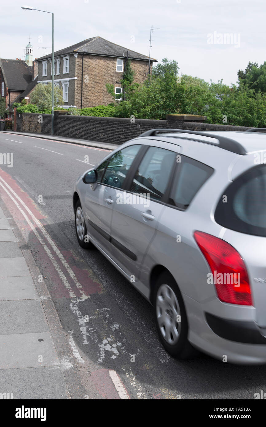 a car passes an extremely narrow cycle lane in richmond upon thames