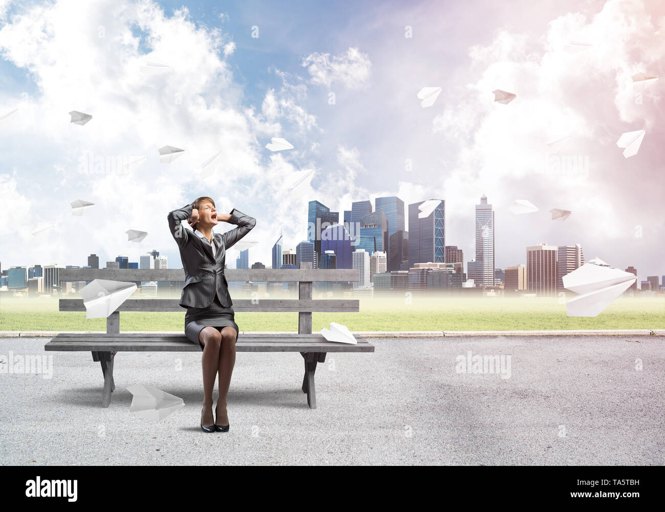 Stressful woman sitting on wooden bench Stock Photo