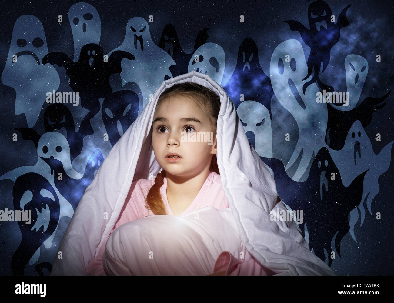 Scared girl with pillow hiding under blanket Stock Photo Alamy