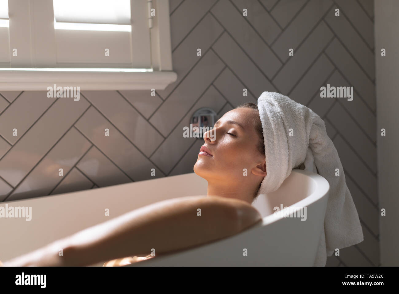 Beautiful woman relaxing in the bathtub Stock Photo