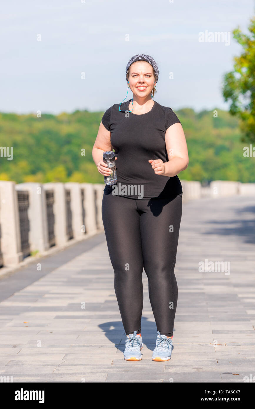 over size woman while jogging in the early morning in the park Stock Photo Alamy