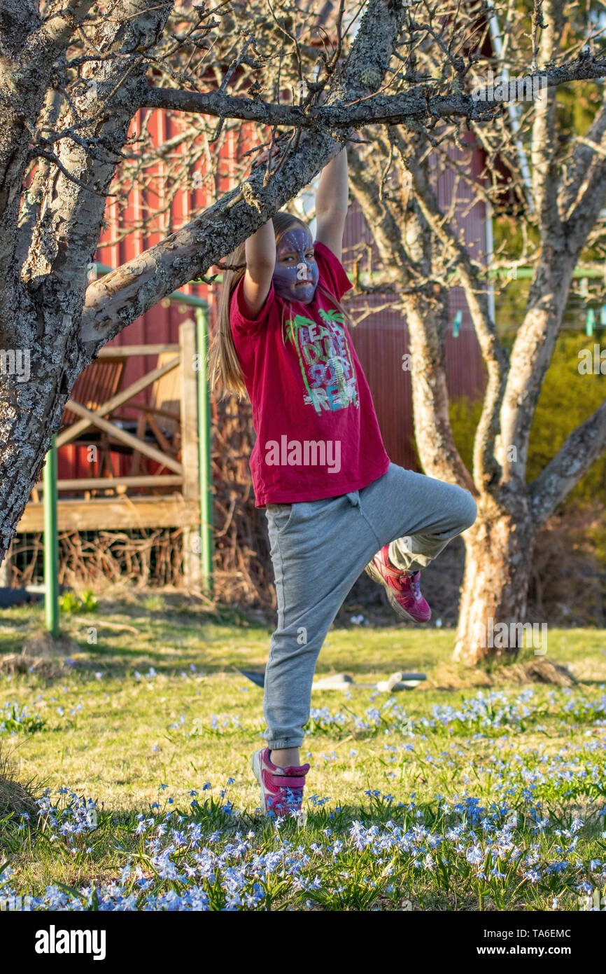 Girl climbing tree Stock Photo