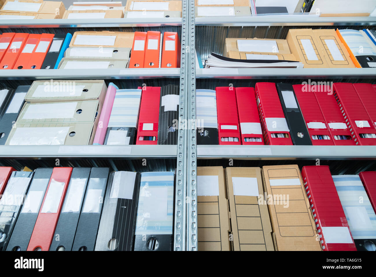 Colourful blank blind folders with files in the shelf. Archival, stacks