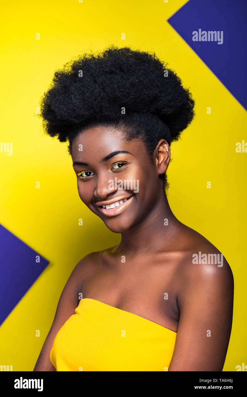Smiling Pretty African American Woman Looking At Camera On Yellow
