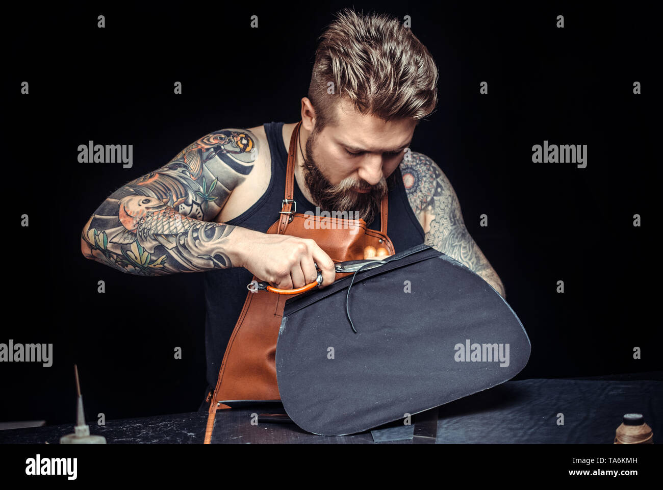 Leather Skinner produce a leatherwork in studio Stock Photo