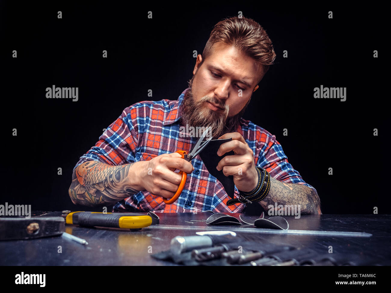 Leather master making quality products in a workshop Stock Photo