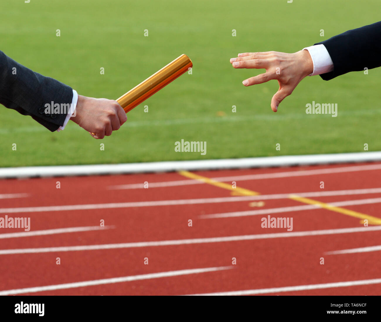 Businessman passing baton in relay race Concept Teamwork Succession