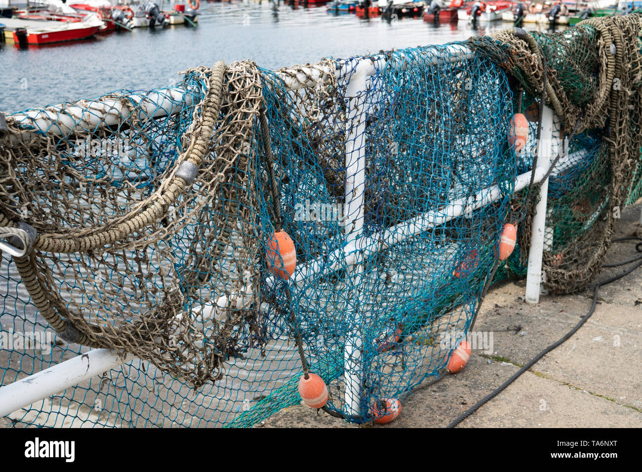 Fishing net on dock port with defocus background. Galicia Spain Stock Photo  - Alamy