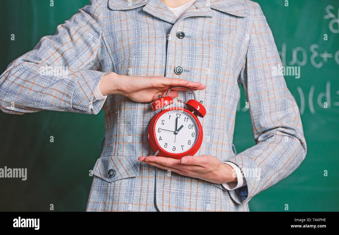 Schedule and regime. Alarm clock in female hands close up. Teachers
