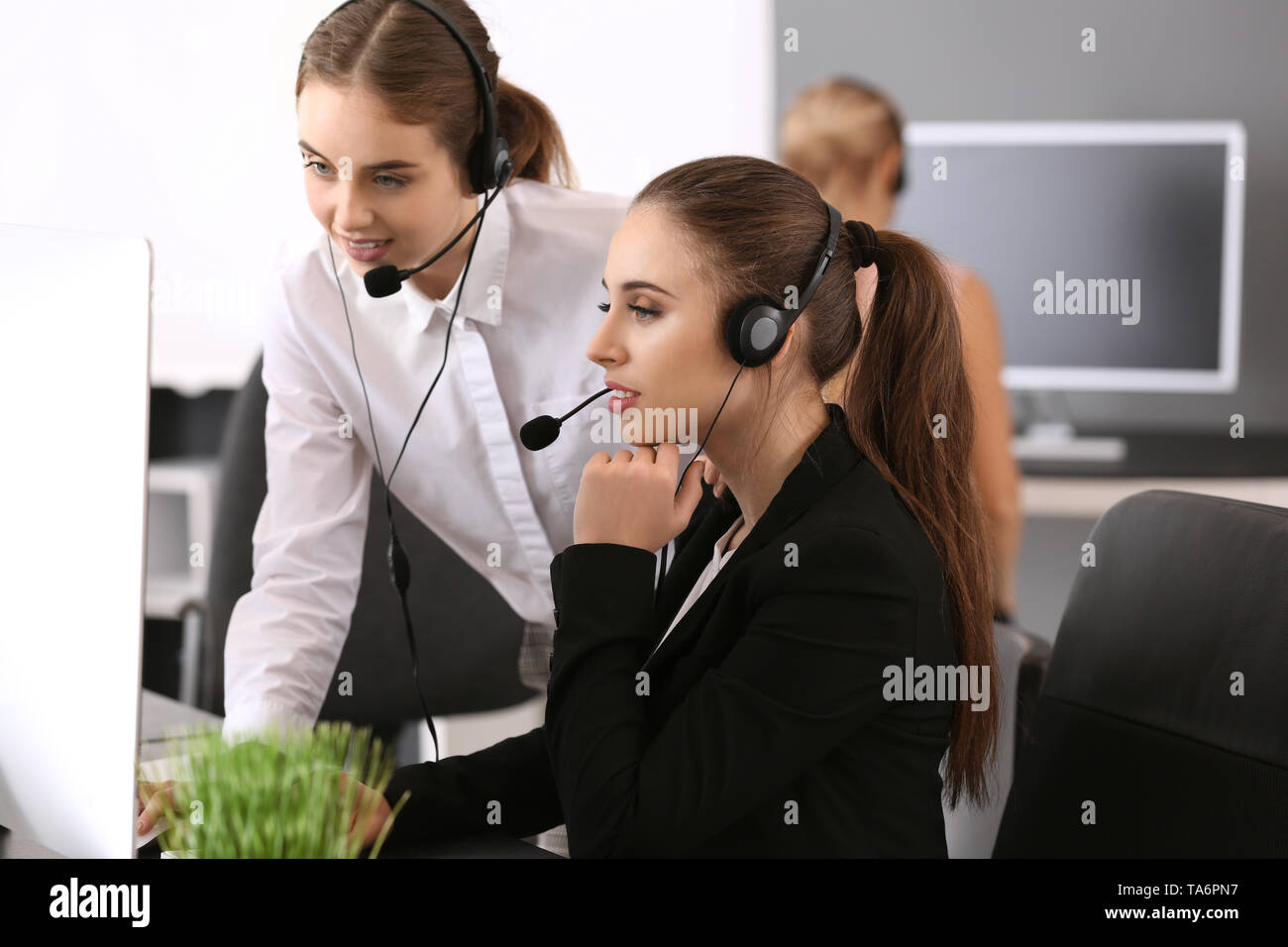 Technical support agents working in office Stock Photo - Alamy